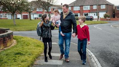 Young family going to school with man