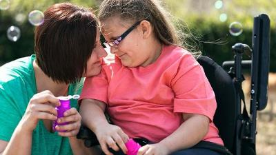 Woman young girl in pink tshirt in wheelchair