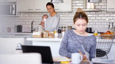 Parent and baby foster carer in kitchen