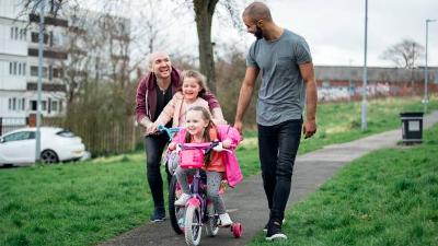 Males with two children on bicycles